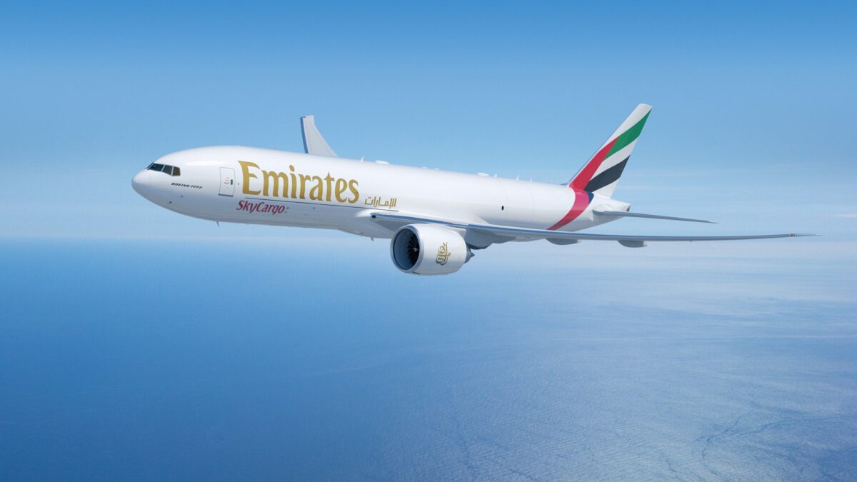 emirates 777 flying in blue sky