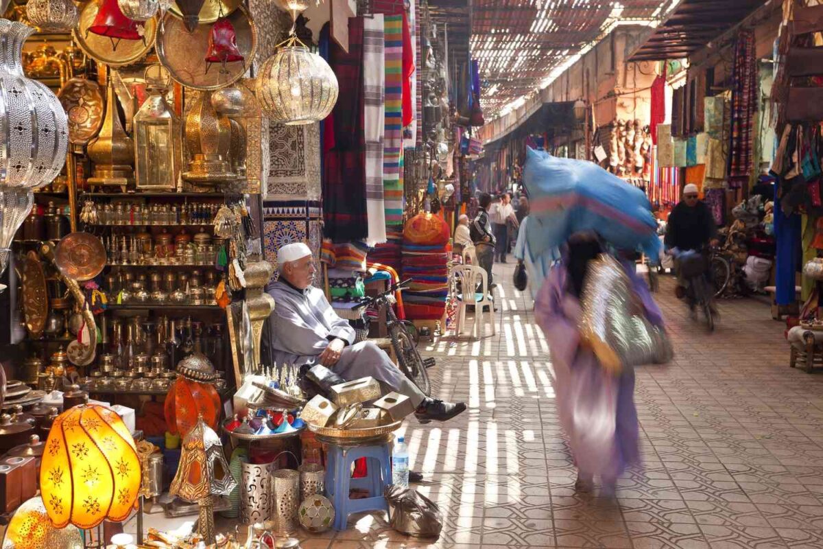 man sitting at a store in the Marrakesh souk