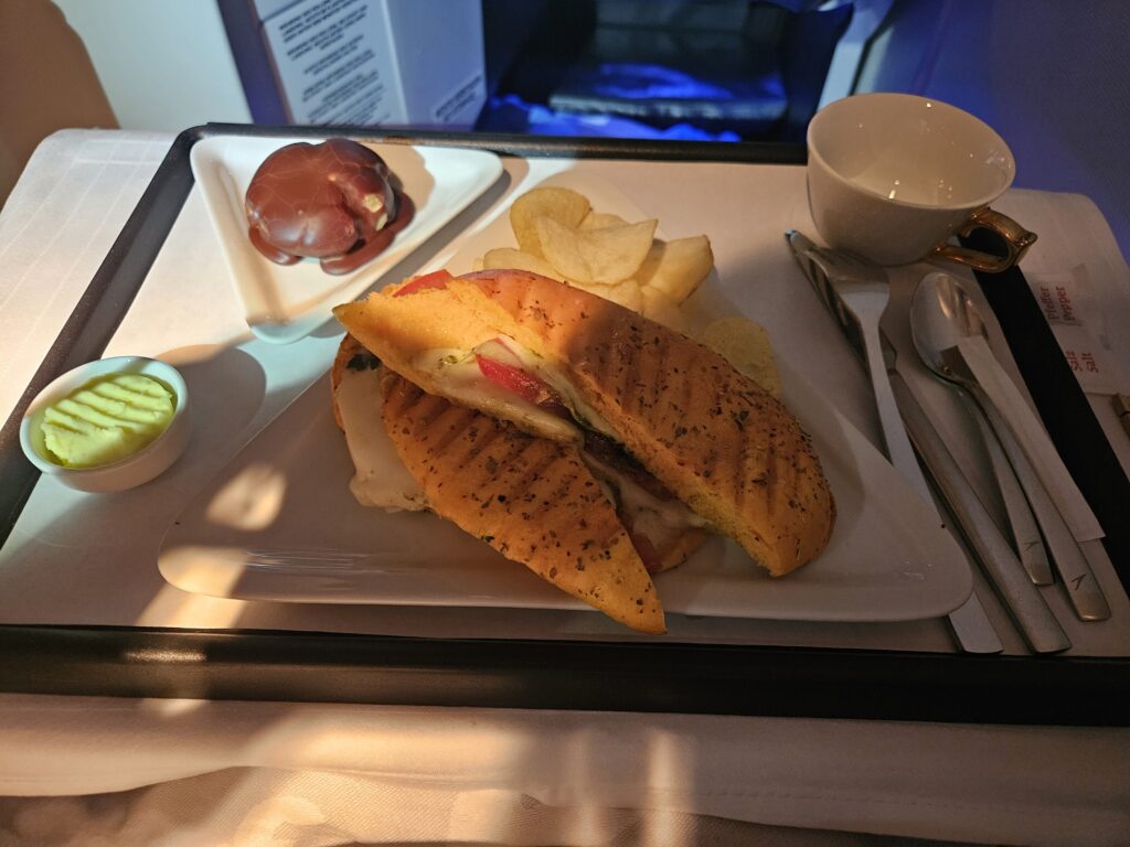 business class austrian airlines end of flight panini chips dessert coffee coffee cup