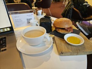 virgin atlantic business class upper class arrivals lounge food bacon roll mustard coffee cream milk